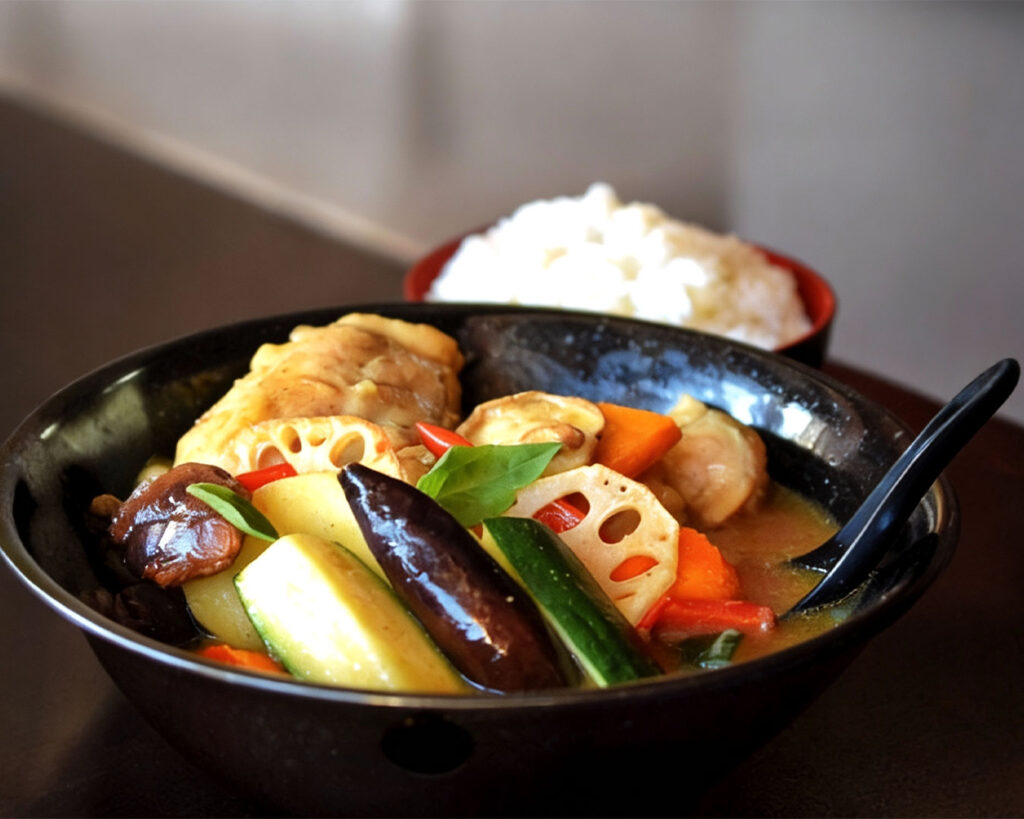 The art of authentic Hokkaido soup curry, presented with a clear, spice-forward broth, carefully selected ingredients, and refined Japanese culinary craftsmanship.