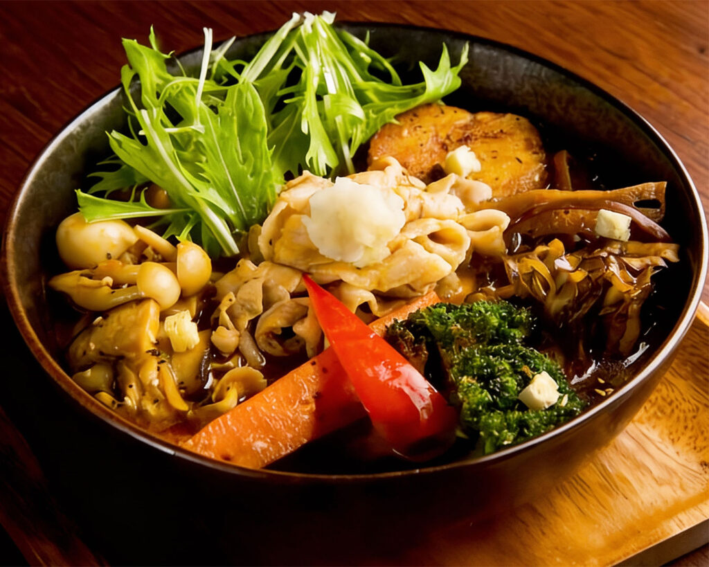 A representation of authentic Hokkaido soup curry, highlighting its signature light yet flavourful broth, bold spices, and traditional Japanese preparation.