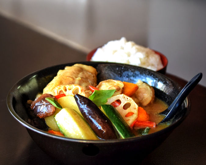 The art of authentic Hokkaido soup curry, presented with a clear, spice-forward broth, carefully selected ingredients, and refined Japanese culinary craftsmanship.