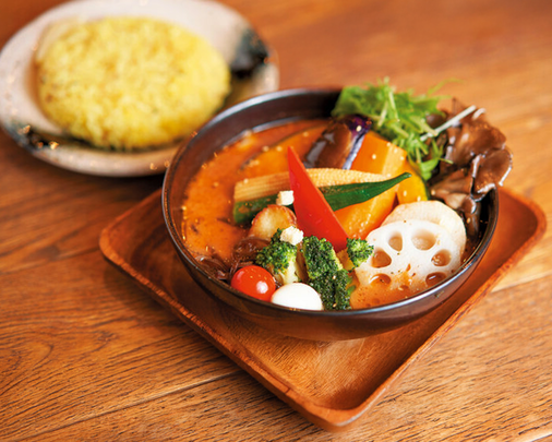 An authentic Hokkaido soup curry experience, showcasing a fragrant broth, vibrant seasonal ingredients, and the depth of flavours unique to northern Japan.