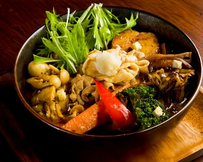 A representation of authentic Hokkaido soup curry, highlighting its signature light yet flavourful broth, bold spices, and traditional Japanese preparation.