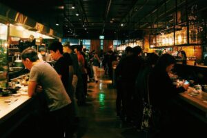 A group of people enjoying their meal in the evening hours of a Singapore restaurant serving Japanese delicacies.