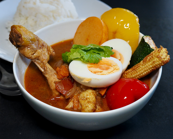 Tender chicken simmered gently in soup curry, absorbing spices while remaining juicy and flavourful.