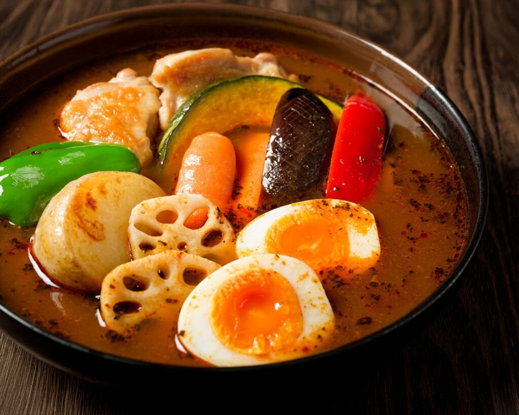 A wholesome bowl of soup curry packed with vegetables and protein, highlighting balanced nutrition and natural ingredients in every serving.